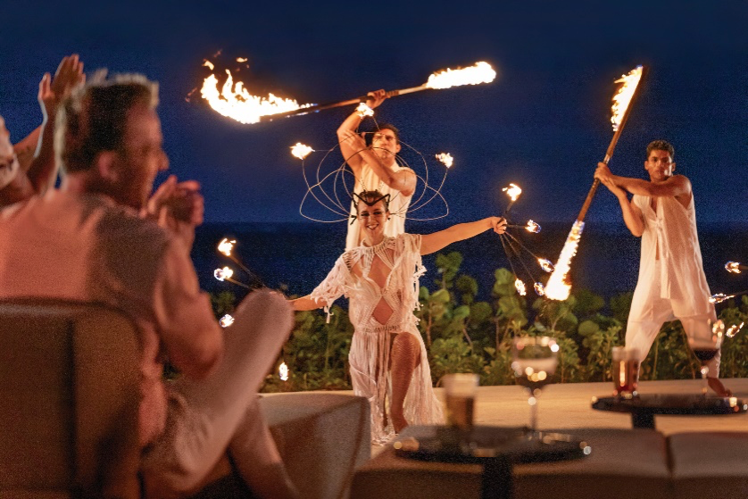 Fire performers entertaining guests at an outdoor evening event